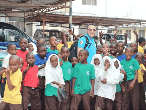 Excited students posing for a photo with a Sabili Foundation member.