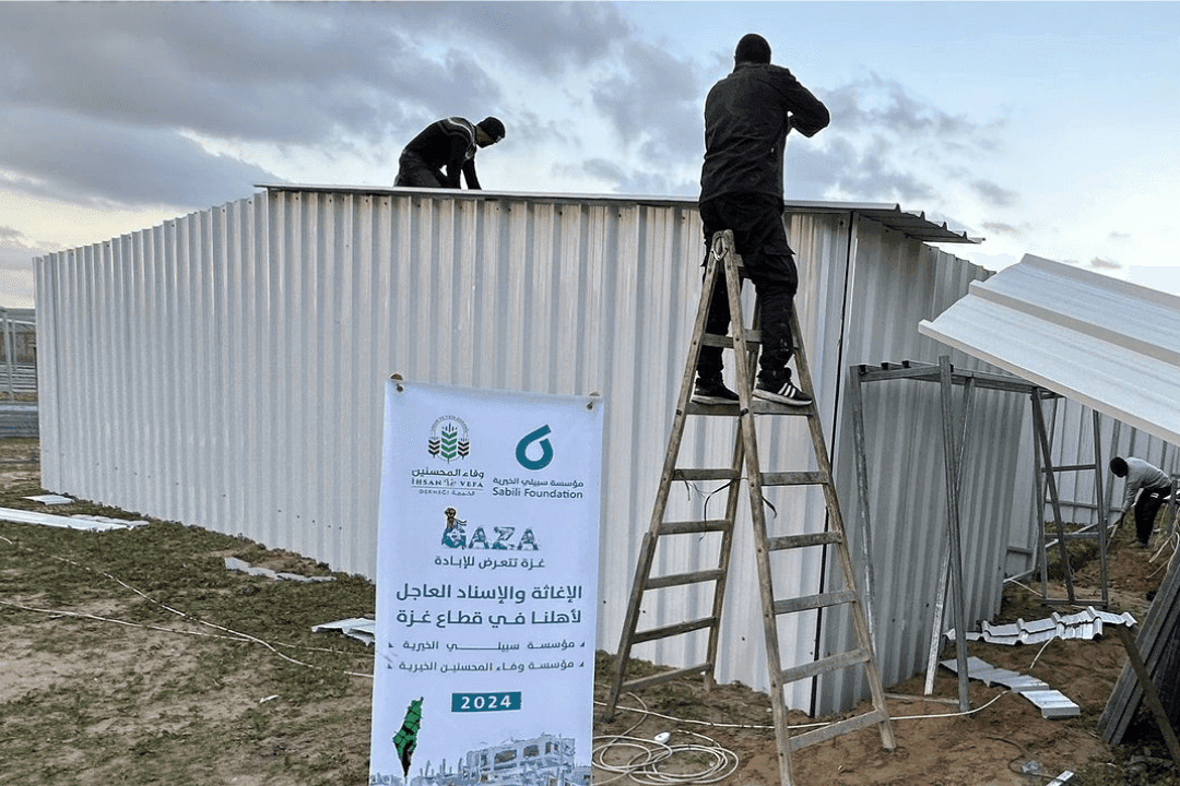 A group of men preparing shelters for the displaced