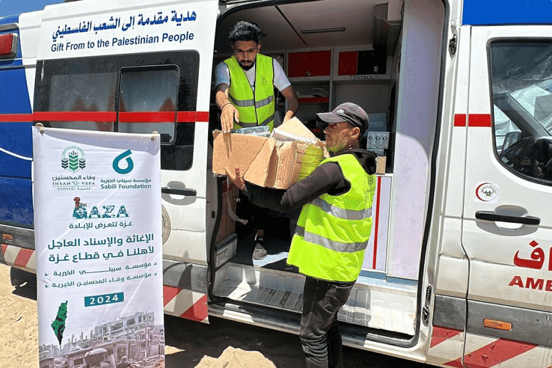 Ambulance workers distribute medicine to a medical camp in Gaza